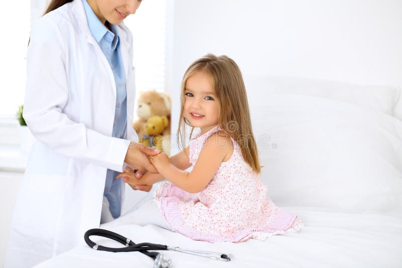 Doctor examining a little girl by stethoscope stock photos Doctor examining a little girl by stethoscope stock photos
