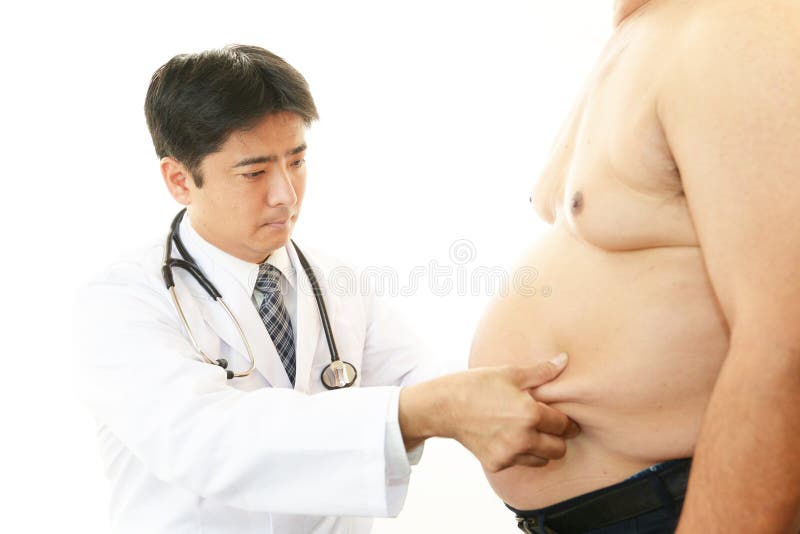 Doctor examining a patient obesity stock image