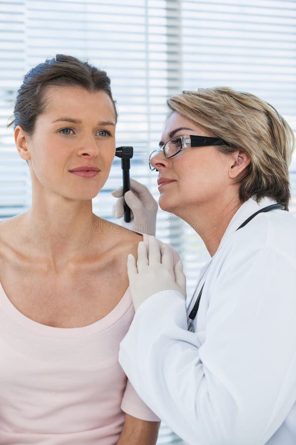 Doctor Examining Patients Ear With Otoscope Stock Image Image Of