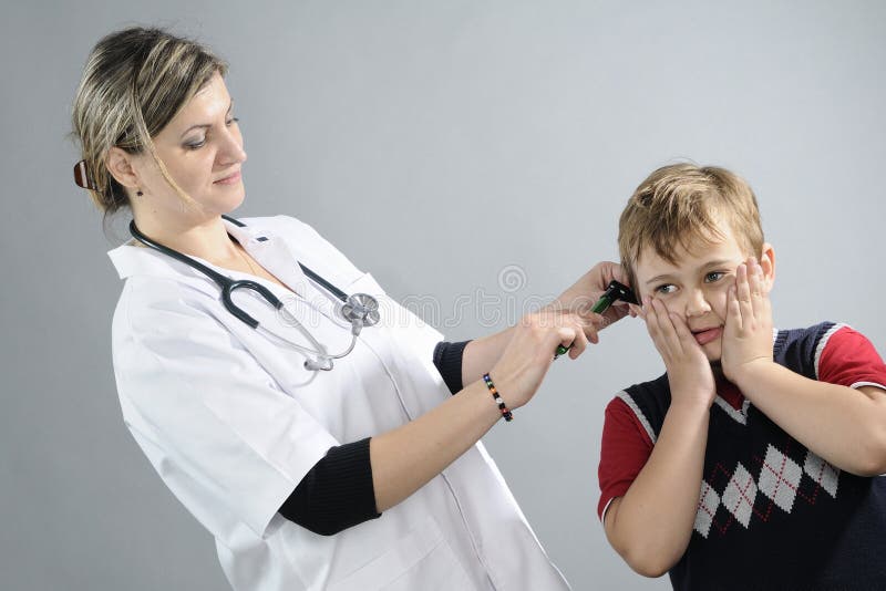 doctor examining school boy