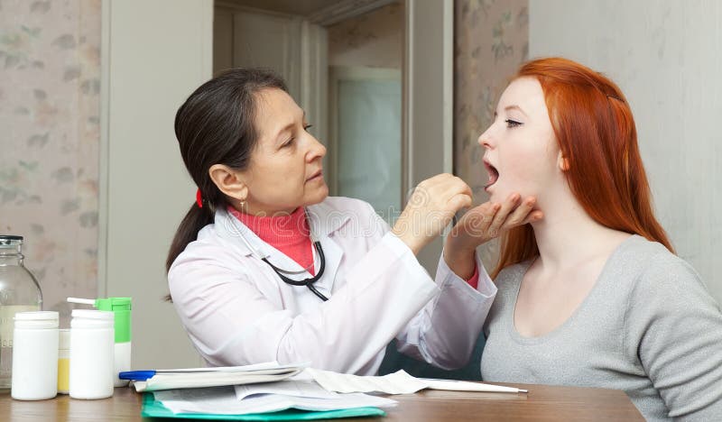 Doctor Examining Throat Of Teen Patient Stock Image Image Of