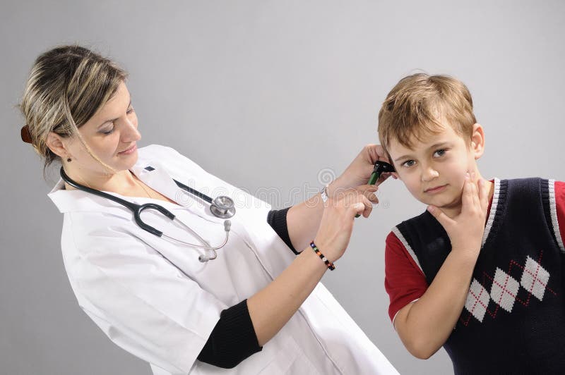 Doctor examining white boy