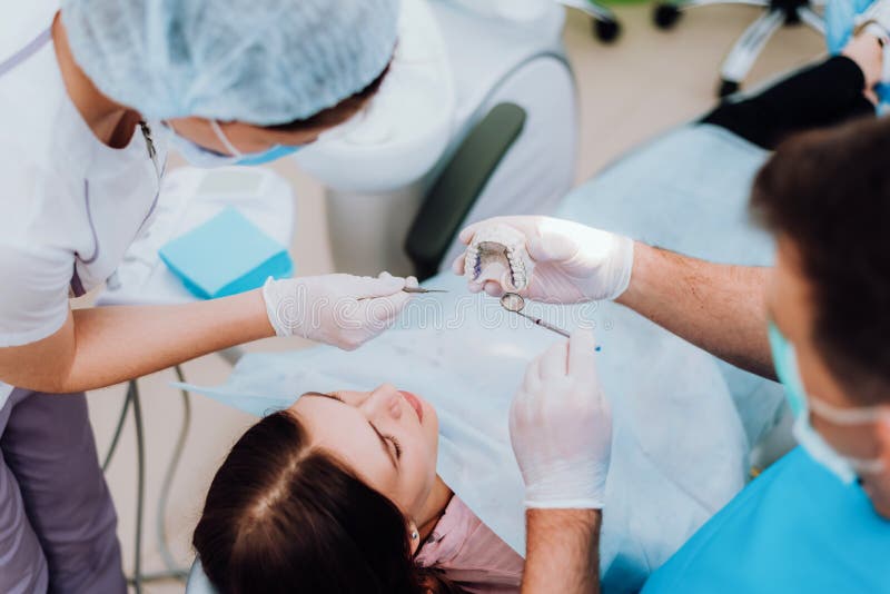 Doctor orthodontist explains to the patient how he will treat her royalty free stock photography Doctor orthodontist explains to the patient how he will treat her royalty free stock photography