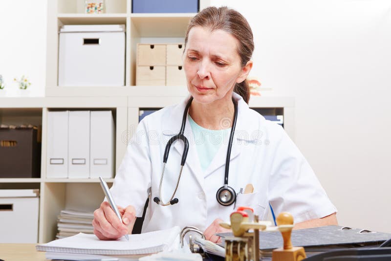 Doctor with files in her office royalty free stock image