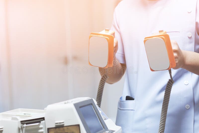 The doctor is giving a defibrillators to save the patient& x27;s life in the hospital stock photos The doctor is giving a defibrillators to save the patient& x27;s life in the hospital stock photos