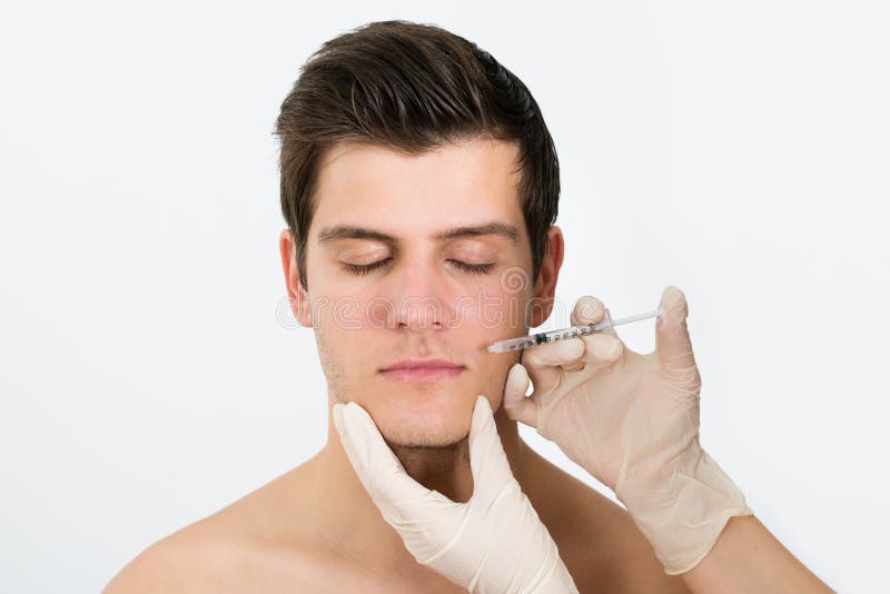 Doctor Hands Injecting Botox Injection In Man Face royalty free stock image Doctor Hands Injecting Botox Injection In Man Face royalty free stock image