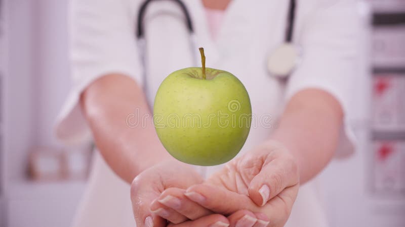 Doctor hands presenting a virtual apple over palms