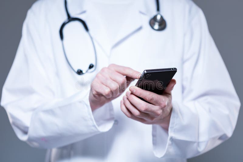 Doctor hands using mobile phone royalty free stock image