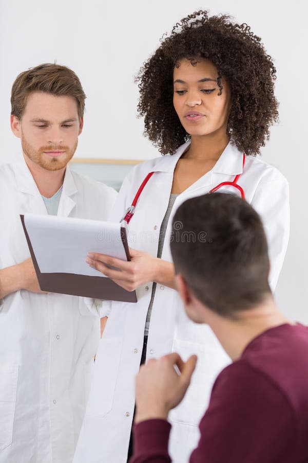 Doctor holding clipboard with patient medical record chart stock image Doctor holding clipboard with patient medical record chart stock image