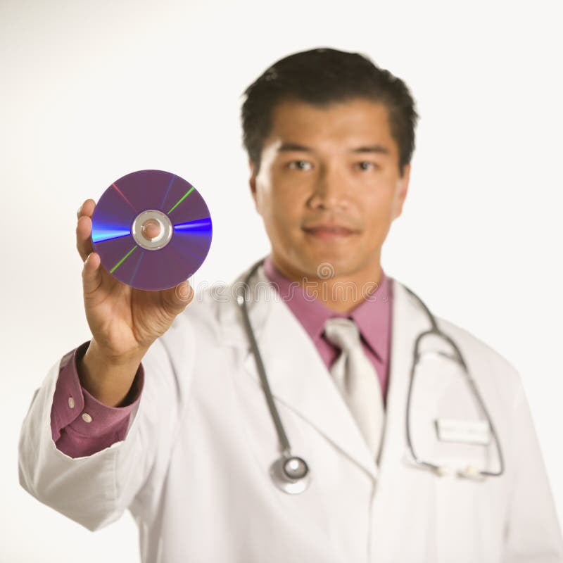 Doctor holding compact disc. stock photo
