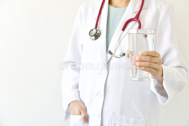 Doctor holding a glass of clear fresh water. stock photography Doctor holding a glass of clear fresh water. stock photography