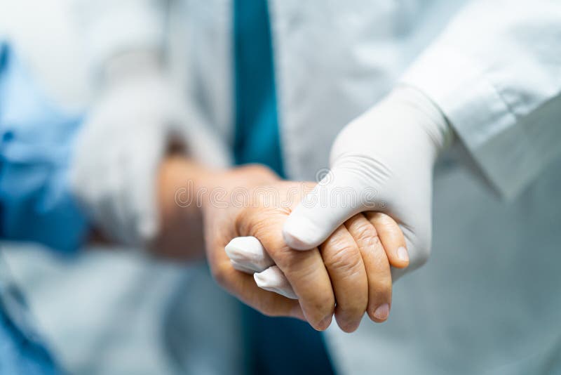 Doctor holding hands Asian senior or elderly old lady woman infected patient with love, care, helping, encourage and empathy in qu