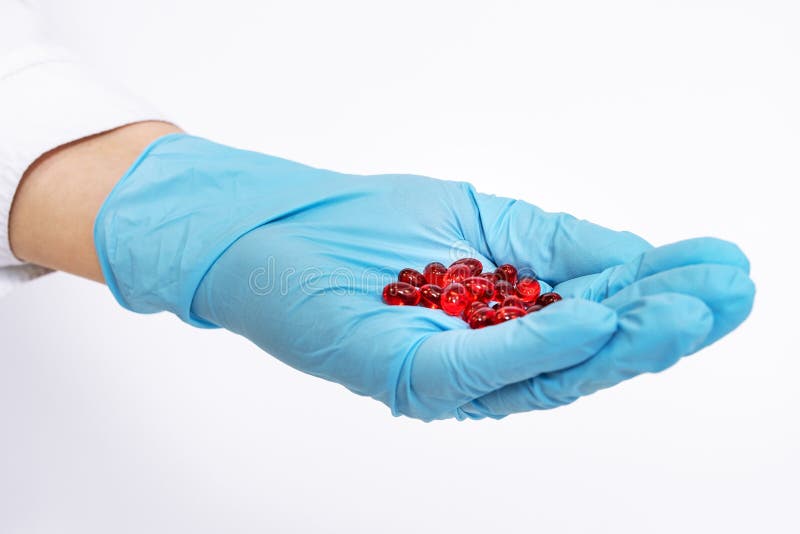 Doctor holding medical red drugs, pills, pills, hands with gloves. Placebo drugs concept. Treatment and health care. medicine for royalty free stock image Doctor holding medical red drugs, pills, pills, hands with gloves. Placebo drugs concept. Treatment and health care. medicine for royalty free stock image