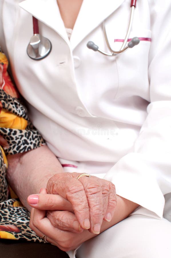 A doctor holding an old woman s hand