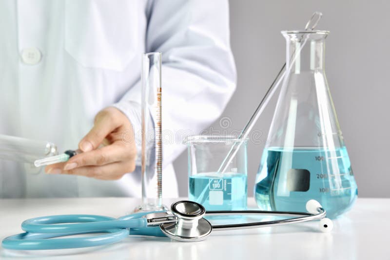 Doctor holding syringe with medicinal vaccine, Laboratory glassware. royalty free stock image Doctor holding syringe with medicinal vaccine, Laboratory glassware. royalty free stock image