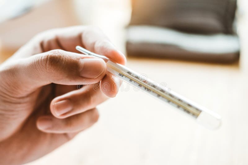 Doctor holding on thermometer for checking sick patient Health care in hospital stock photo Doctor holding on thermometer for checking sick patient Health care in hospital stock photo