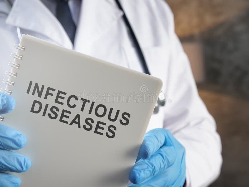 A Doctor Holds Book about Infectious Diseases. Stock Photo Image of