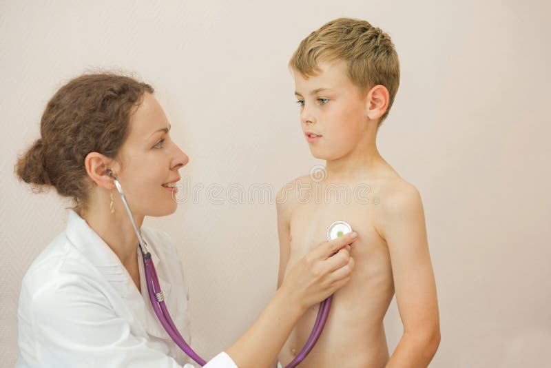 Doctor listens to lungs of boy with stethoscope