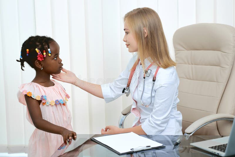 Doctor and little girl on medical examination. royalty free stock image.