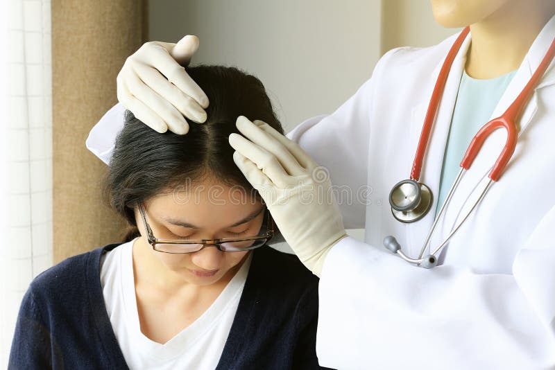 Doctor looking at patient`s hair and scalp, Dermatologist exam scalp disorder.