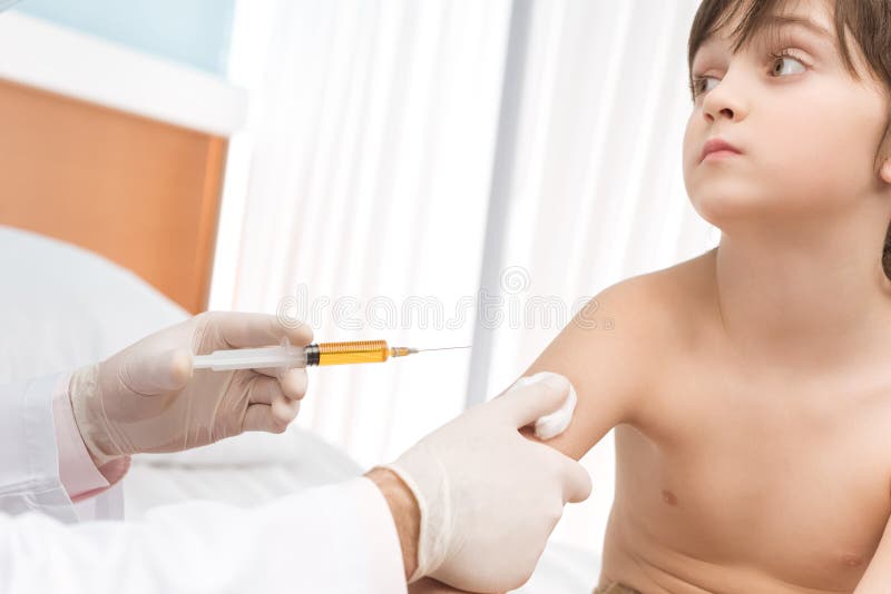 Doctor making injection to little boy in hospital royalty free stock images Doctor making injection to little boy in hospital royalty free stock images