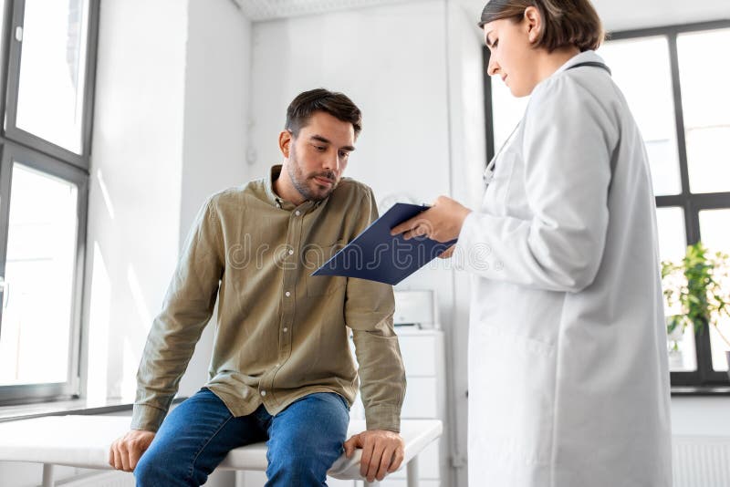 Doctor and man with health problem at hospital stock images