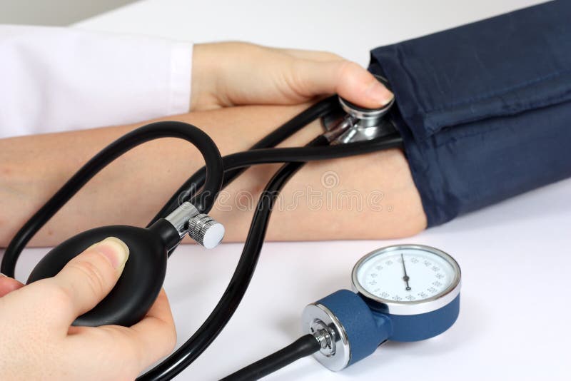 Doctor measuring patient blood pressure