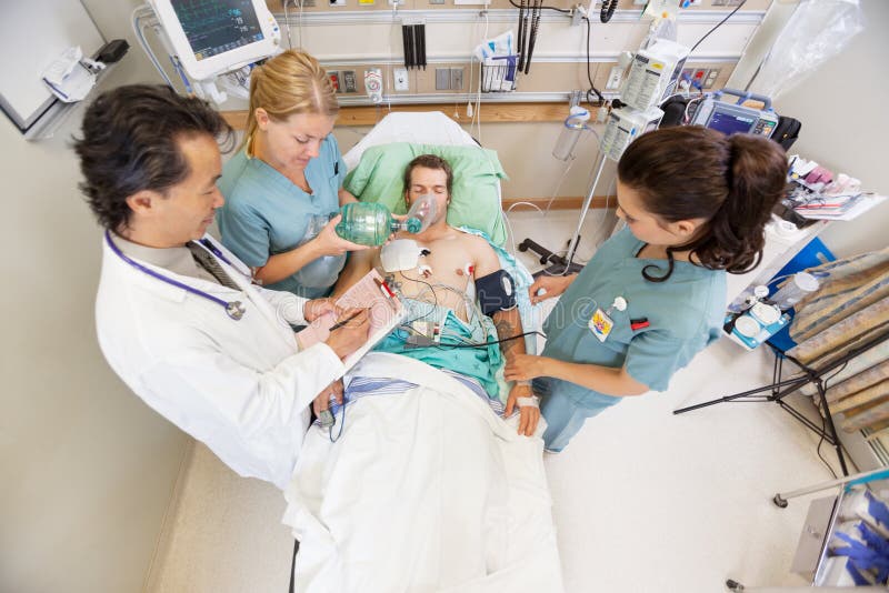 Doctor And Nurses Treating Critical Patient In