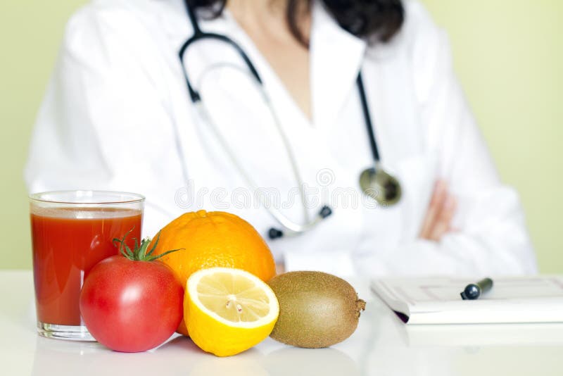 Doctor nutritionist in office with healthy fruits stock images Doctor nutritionist in office with healthy fruits stock images