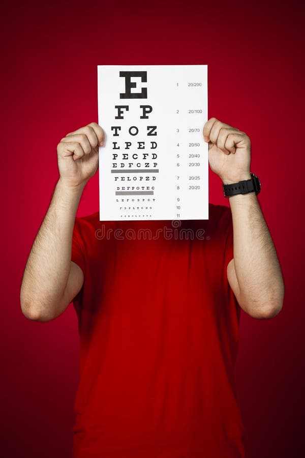 Doctor optometrist keeping an eye chart royalty free stock photo