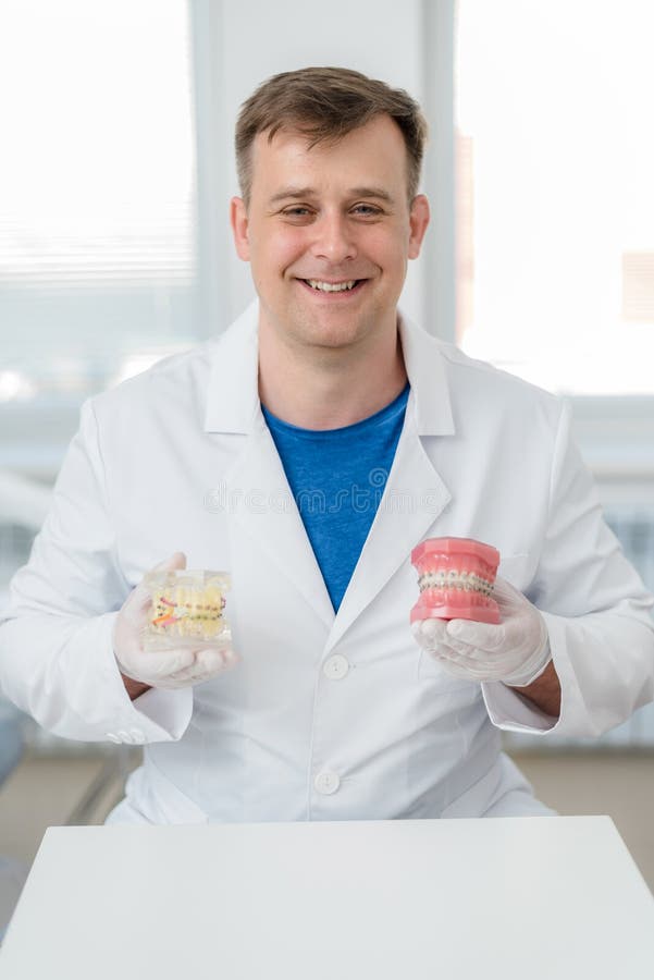 Doctor Orthodontist Shows How the System of Braces on Teeth is Arranged