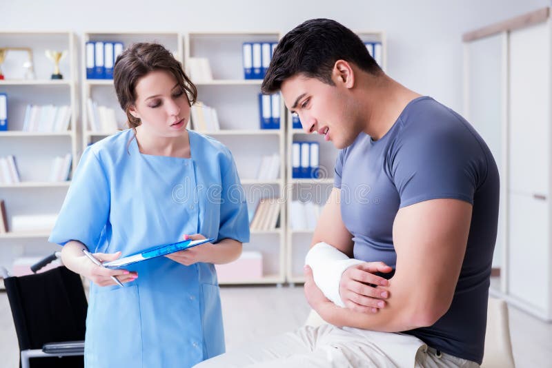The Doctor And Patient During Check Up For Injury In Hospital Stock