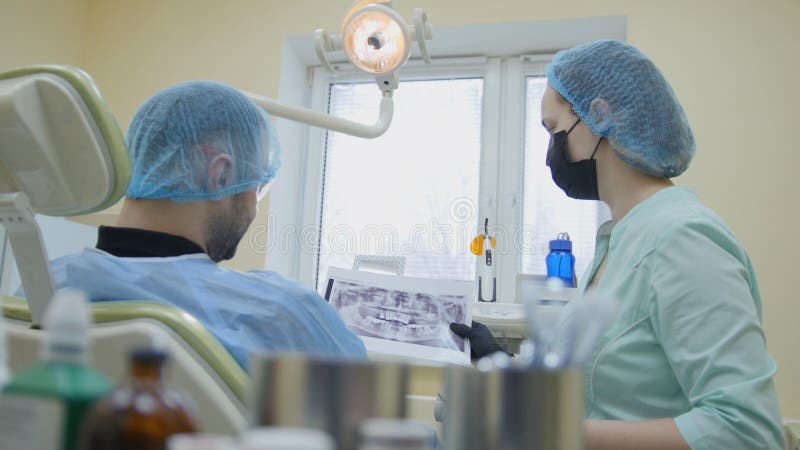 Doctor and patient in the dental office, examination the mouth royalty free stock image Doctor and patient in the dental office, examination the mouth royalty free stock image