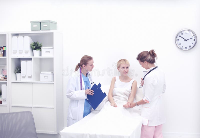 Doctor and patient discussing something while sitting at the table . Medicine and health care concept royalty free stock photography Doctor and patient discussing something while sitting at the table . Medicine and health care concept royalty free stock photography