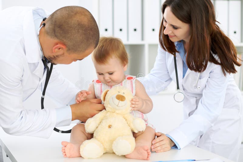 Doctor and patient. Happy cute baby at health exam. Medicine and health care concept. Female, lovely.