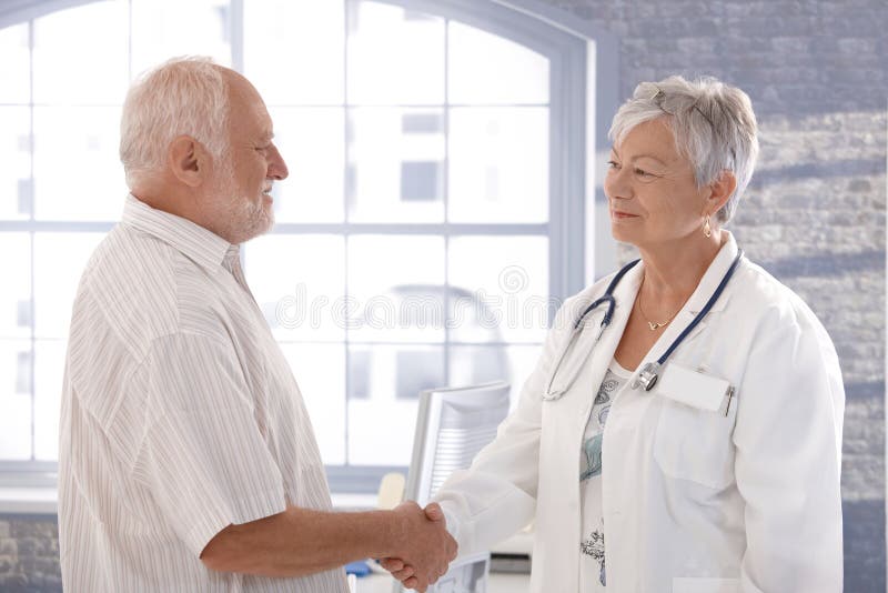 Doctor and patient shaking hands smiling royalty free stock photo Doctor and patient shaking hands smiling royalty free stock photo