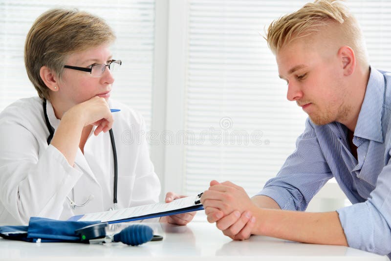 Doctor talking to her male patient at office. Doctor talking to her male patient at office