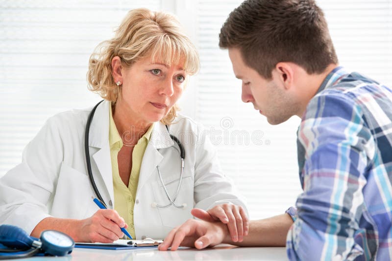 Doctor talking to her male patient at office. Doctor talking to her male patient at office