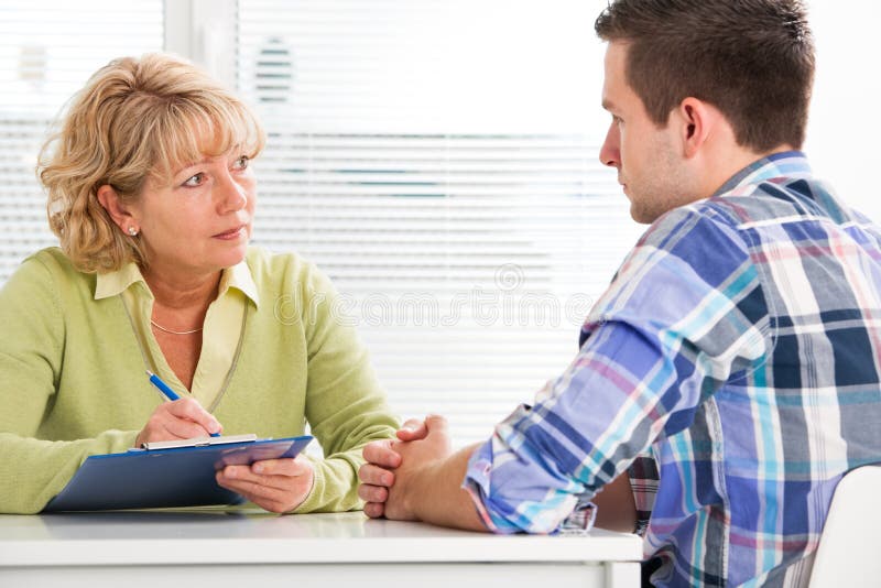 Doctor talking to her male patient at office. Doctor talking to her male patient at office