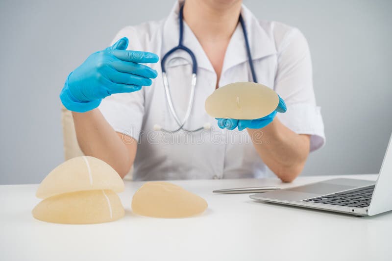 Doctor Plastic Surgeon Explains the Benefits of Different Breast Implants. Stock Image Image