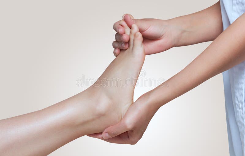 The doctor-podiatrist does an examination and massage of the patient`s foot