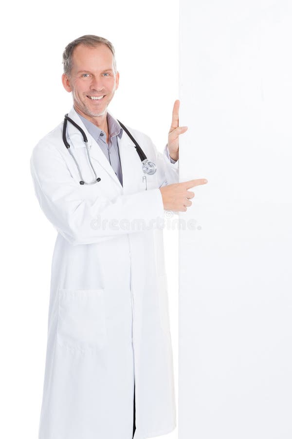 Portrait Of Happy Mature Male Doctor Pointing On Placard