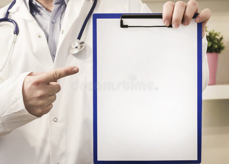 Doctor wearing a stethoscope pointing to a clipboard with a blank sheet of white paper with copy space for your text, close up view on his hands and chest. Doctor wearing a stethoscope pointing to a clipboard with a blank sheet of white paper with copy space for your text, close up view on his hands and chest
