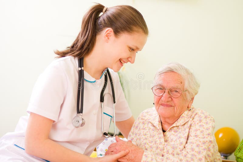 Doctor que cuida con la mujer mayor feliz imagen de archivo Doctor que cuida con la mujer mayor feliz imagen de archivo