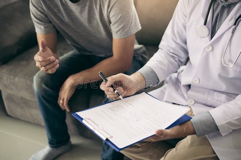 Doctor is Recording the Patient`s Information while the Patient is