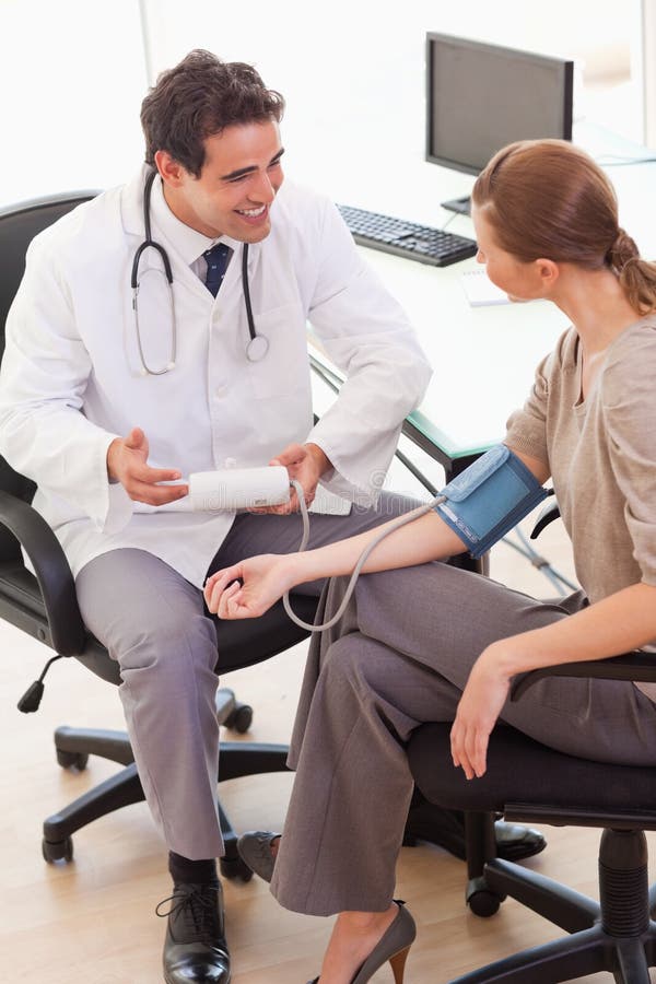 Doctor is relieved after taking his patients blood pressure stock images