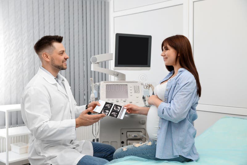 Doctor showing ultrasound images of baby to future mother royalty free stock images Doctor showing ultrasound images of baby to future mother royalty free stock images