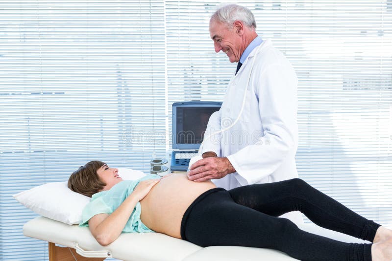 Doctor showing ultrasound monitor to woman royalty free stock images Doctor showing ultrasound monitor to woman royalty free stock images