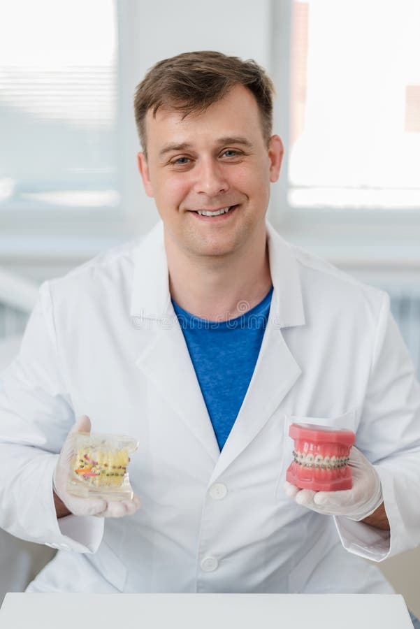 Doctor Orthodontist Shows How the System of Braces on Teeth is Arranged