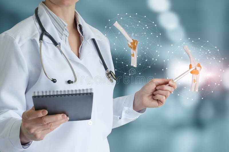 Doctor shows a model of a joint on a virtual screen royalty free stock photo